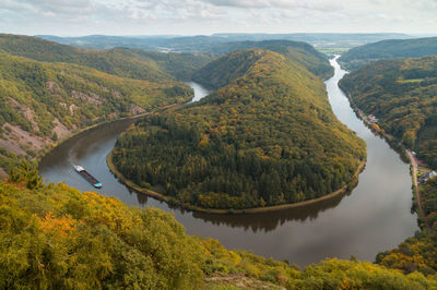 High angle view of river amidst mountains against sky