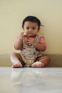 Portrait of cute boy against wall