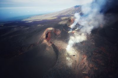 Aerial view of land and sea against sky