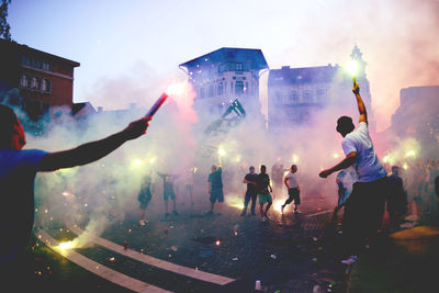 People bursting firework at street