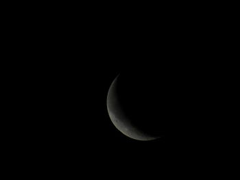 Low angle view of moon in the dark