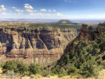 Rock formations on landscape against sky