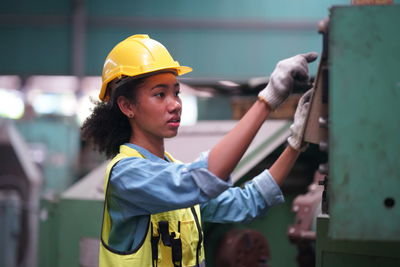 Side view of man working in factory