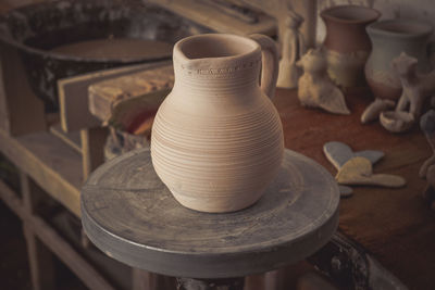 Clay jug on a potter's wheel close-up. copy spase