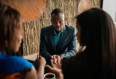 Business person having discussion while standing in office