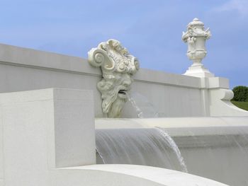 Statue against white sky