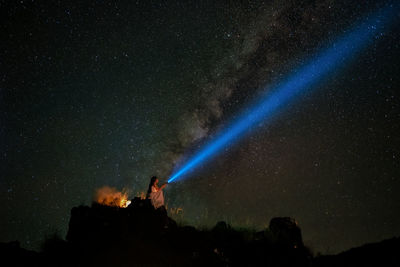 Man against blue sky at night