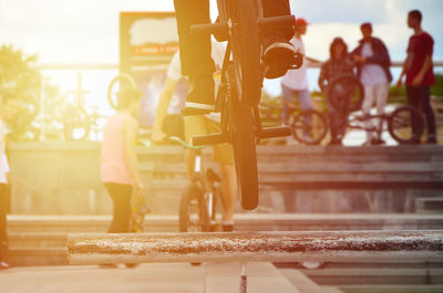 People doing stunts on bicycle at park