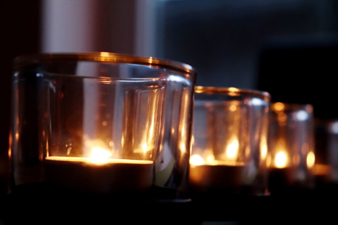 CLOSE-UP OF TEA CANDLES ON GLASS
