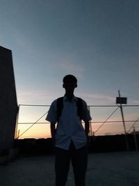 Silhouette man standing against sky during sunset