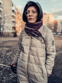 Portrait of young woman standing outdoors