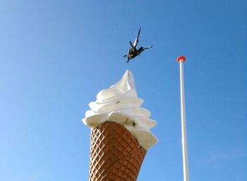 Low angle view of statue against clear blue sky