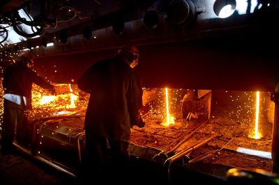 Workers welding in workshop