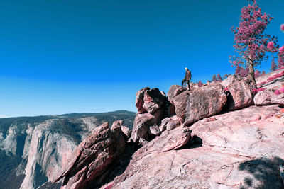 Rock formations on mountain against blue sky