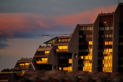 Low angle view of buildings against sky during sunset