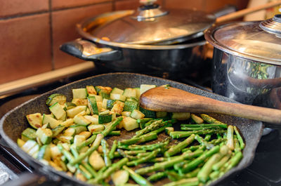 Close-up photo of asparagus and zucchini in frying pan