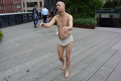 Full length of shirtless boy standing outdoors