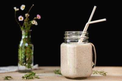 Close-up of drink in glass jar on table