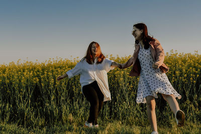 Friends standing on field