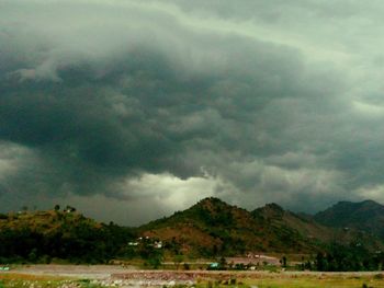 Scenic view of mountains against cloudy sky