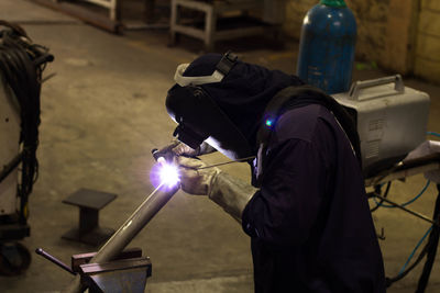 Welder welding in workshop