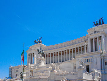 Low angle view of statue against blue sky