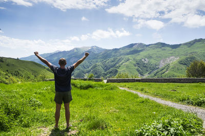 Full length of man standing on field against sky