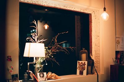 Illuminated lamp on table at home