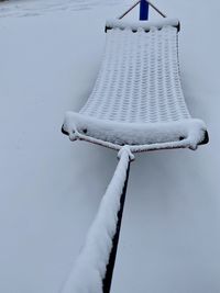 Close-up of snow covered bicycle on field