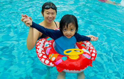 Mother and daughter in swimming pool