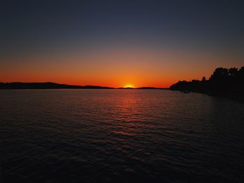 Scenic view of sea against romantic sky at sunset