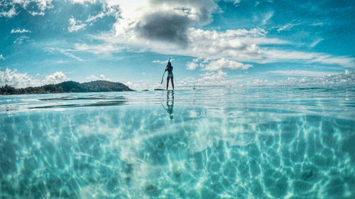 Silhouette man in swimming pool against sea