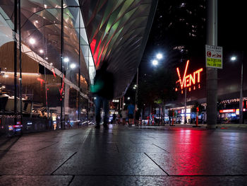 Illuminated city street at night