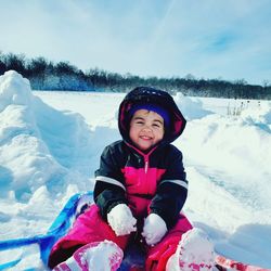 Cute girl smiling in snow during winter