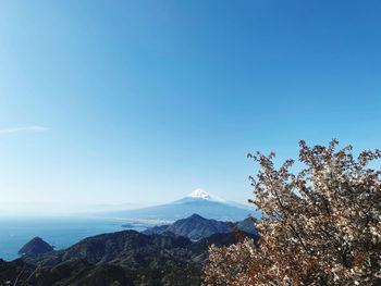 Scenic view of snowcapped mountains against clear blue sky