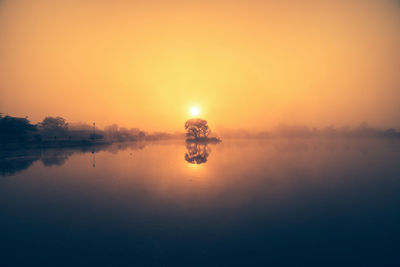 Scenic view of lake against sky during sunset