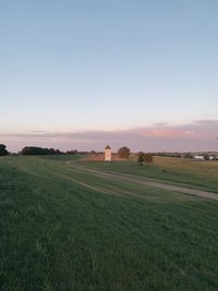 Scenic view of field against sky during sunset