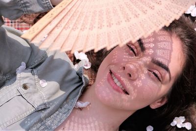 Close-up portrait of young woman lying down