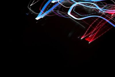 Close-up of light trails over black background