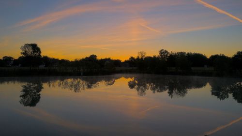 Scenic view of lake against sky during sunset