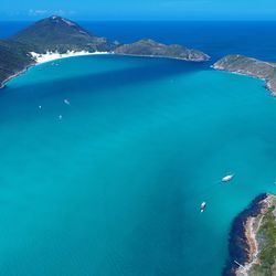 High angle view of sea by mountain against sky