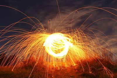Close-up of illuminated fireworks against sky at night