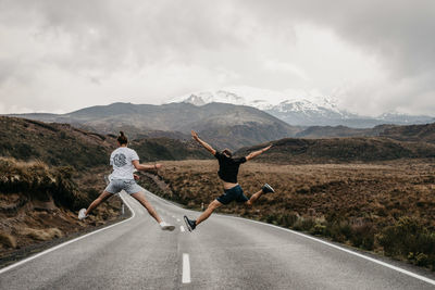 People on road against mountain range