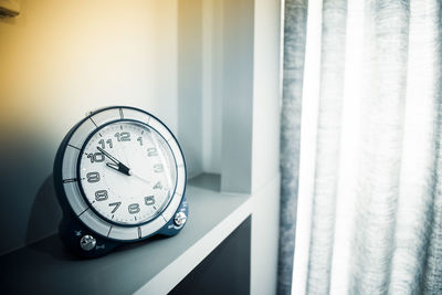 Close-up of clock on table