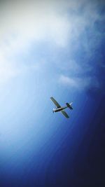 Low angle view of airplane flying in sky