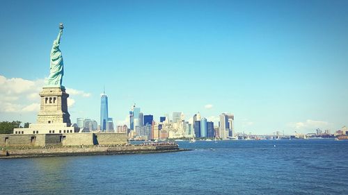 Statue of liberty against buildings