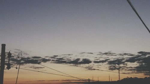 Low angle view of electricity pylon against sky