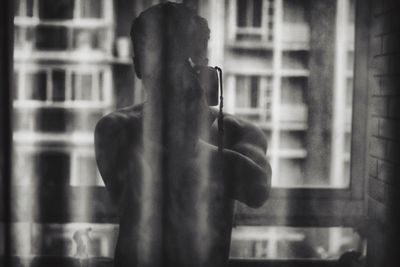 Midsection of man using mobile phone