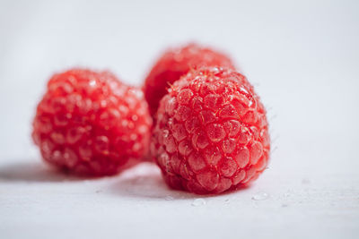 Close-up of strawberry on table against white background