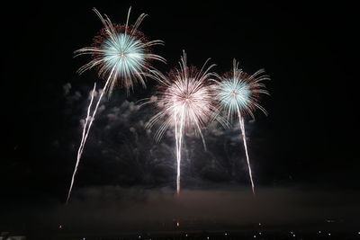 Low angle view of firework display at night